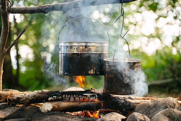 aluminum bowlers hang over a smoking fire in a summer forest tourism and travel - Организация трапезы в походе: хранение продуктов, походная кухня, утварь, меню